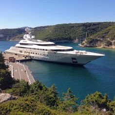 a large white boat is docked in the water