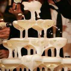 there is a fountain made out of ice and wine glasses in the shape of fountains