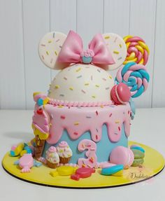 a mickey mouse cake with sprinkles and candy