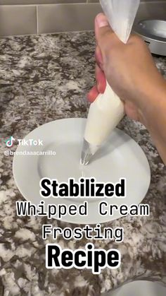 someone is using a whipped cream frosting recipe on a counter top with the words, stabilized whipped cream frosting recipe