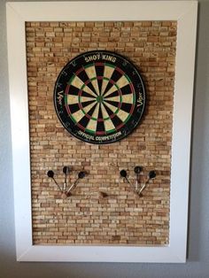 a dart and three darts mounted to a wall