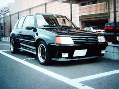 a black car parked in front of a building