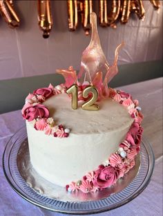 a birthday cake decorated with pink flowers and the number twenty two on it's top