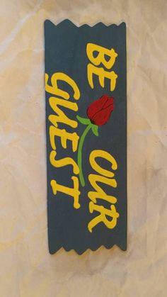 a sign that says be quiet on the wall with a flower painted on it's side