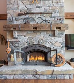 a stone fireplace with a clock on the mantle