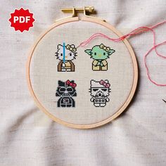 the cross stitch pattern is being displayed in front of an embroidery hoop with scissors and thread