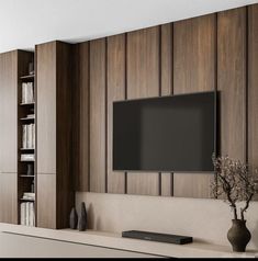 a flat screen tv mounted to the side of a wall next to a book shelf