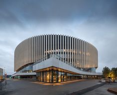 a large building with a circular design on the front and side of it's face