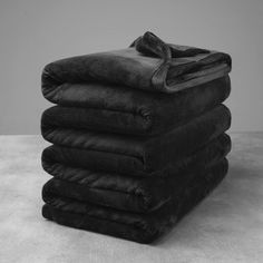 a stack of black towels sitting on top of each other