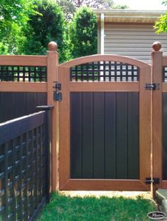 a wooden gate in front of a house