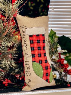 a christmas stocking pillow sitting on top of a mantle