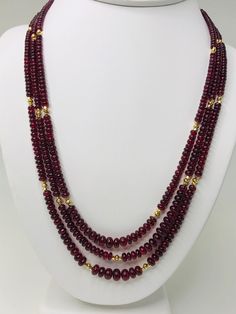 This strand of fine quality spinel beads would be at home in a 19th century ballroom or a 21st century boardroom! Rich, pomegranate red oval rondelles have been hand strung with 22k yellow gold spacers and an 18k yellow gold clasp in an elegant 19-inch strand. I have never seen red spinel beads before! Spinels have often been mistaken for fine rubies throughout history and looking at this strand, it is easy to see why. The beads, graduating in size from 3.00 to 6.50 millimeters, are of the fines Amber Bead Necklace, Red Spinel, Graduation Necklace, Ruby Beads, Pearl Jewelry Sets, Beaded Jewelry Designs, Amber Beads, Red Bead, Strand Necklace