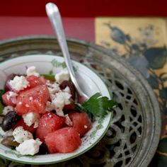 a bowl filled with watermelon and feta cheese