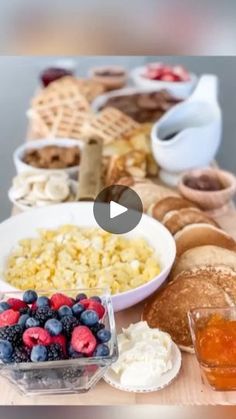 a table topped with lots of different types of breakfast foods and fruit on top of it