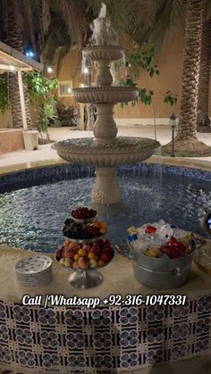 an outdoor fountain with fruit on it