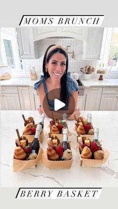 a woman sitting at a kitchen table with some food in small trays on it