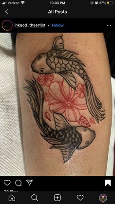 a tattoo on someone's leg that has a fish and flowers in the middle