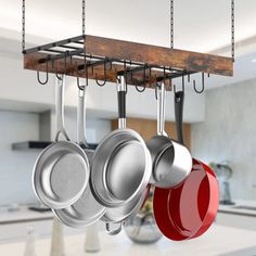 pots and pans hanging from hooks in a kitchen