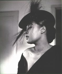 black and white photograph of a woman wearing a hat with hair blowing in the wind