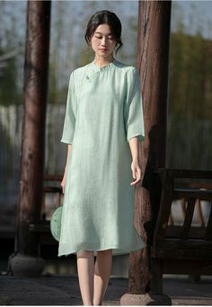 Experience the perfect blend of tradition and modernity with this elegant green qipao cheongsam dress. Made from Tencel fabric, this dress offers unmatched comfort and style, featuring a subtle bamboo leaves print that adds a touch of nature-inspired elegance. Features: Material: Crafted from Tencel fabric, known for its softness, breathability, and eco-friendliness. Design: The dress features a delicate bamboo leaves print, adding a serene and natural element to the overall look. Fit: Loose-fit Green Qipao, Chinese Dress Modern, Cheongsam Modern, Modern Qipao, Green Bamboo, Qipao Cheongsam, Natural Element, Bamboo Leaves, Tencel Fabric