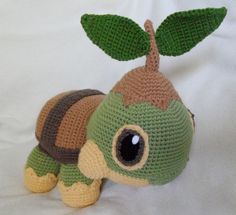 a crocheted stuffed animal with a leaf on its head