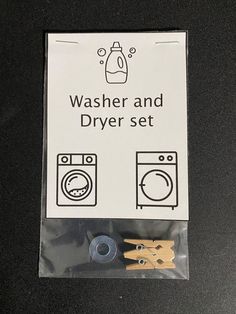 washer and dryer set with wooden clothes pins in plastic bag on black table