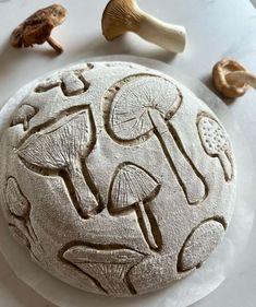 a white plate topped with mushrooms on top of a table next to other food items