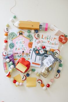 a bunch of items that are laying out on the table together, including pens and magnets