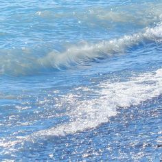 a person riding a surfboard on top of a wave in the ocean at the beach