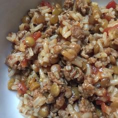 a white bowl filled with rice and meat