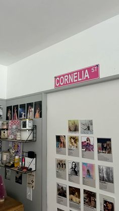 there is a wall with pictures on it and a sign that says cornella st