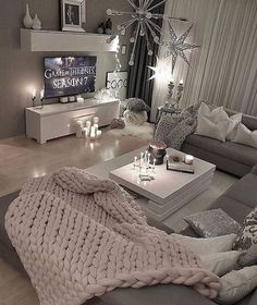 a living room filled with furniture and a large blanket on top of the couches