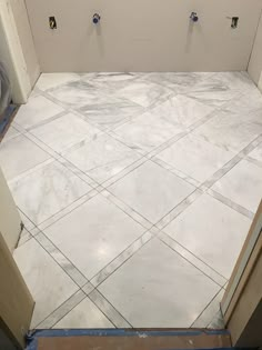 a bathroom that is being remodeled with tile on the floor