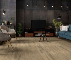 a living room filled with furniture and a flat screen tv on top of a wooden floor