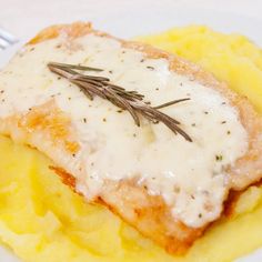 a white plate topped with meat covered in gravy