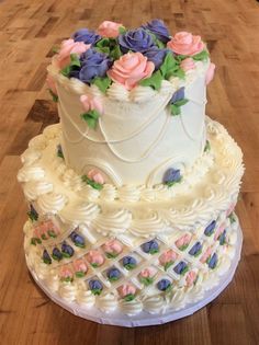 a three tiered cake with flowers on it