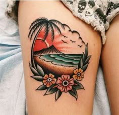 a woman's thigh with a sunset and flowers on it