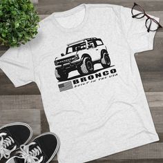 Show off your Bronco love with this fun shirt! This high quality regular fit tee has a casually elegant vibe. Additionally, unbelievably soft tri-blend fabric makes it extremely comfortable - once put on, impossible to take off. .: 50% polyester, 25% combed ringspun cotton, 25% rayon .: Light Fabric  .: Regular fit .: Sewn-in label Ford Bronco Shirt, Bronco Shirt, Usa Shorts, Pocket Tee Shirts, Fun Shirt, Mens Tee Shirts, Mens T Shirts, Ford Bronco, Muscle Tees