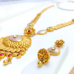 This 22k gold long antique necklace set, weighing 103.5 grams, features a captivating regal design with elegant tassels, an antique finish, and adorned with Kundan and pearl accents. The necklace measures 24 inches in length with a 4-inch drop and includes 0.8-inch adjustable links, secured with a hook lock. The set includes matching earrings, each 2.25 inches in length with a screw back post. Perfect for those who appreciate luxurious and timeless jewelry, this set combines the grandeur of anti Gold Pearl Necklace With Latkans Temple Style, Antique Necklace Set, Bridal Jewelry Necklace, Precious Stones Rings, Diamond Pendant Sets, Regal Design, Modern Bracelets, Fancy Necklace, Fancy Rings