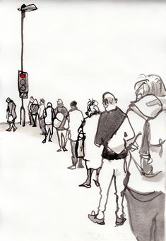 a group of people standing on the side of a road next to a traffic light