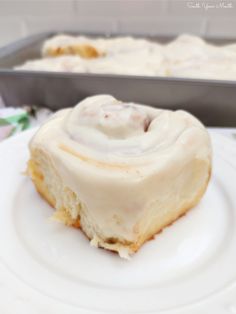 a close up of a doughnut on a plate with a pan in the background