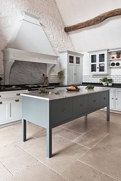 a kitchen with an island in the middle of it