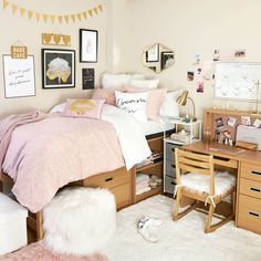 a bedroom with pink and gold bedding on the walls, desks and chairs