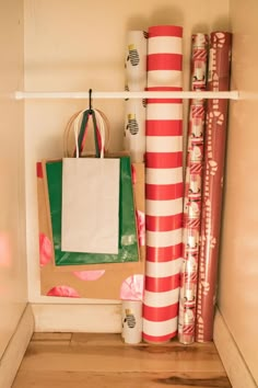 there is a paper bag sitting on the shelf next to some wrapping and gift bags