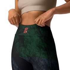 a woman is showing off her leggings with the number 3 on it's side