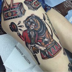 a woman's leg with tattoos on it and an image of a lion playing drums