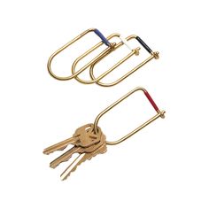 two golden metal key holders with keys on each side and one red, white, and blue handle