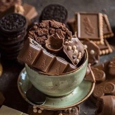 a bowl filled with chocolate and cookies on top of a table