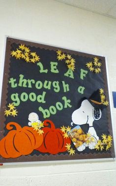 a bulletin board with peanuts and pumpkins on it that says leaf through a good book