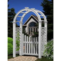 a white wooden gate with a house in the back ground and flowers growing on either side